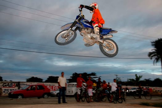 eunapolis, bahia / brazil - june 13, 2008: biker jumps with a motorcycle during motocross training in the city of Eunapolis.