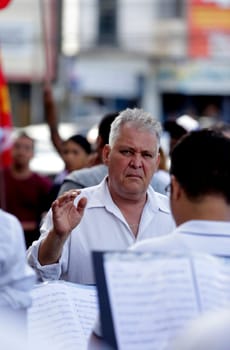 salvador, bahia / brazil - june 28, 2019: Fred Dantas, conductor is seen conducting an orchestra on the street in the city of Salvador.