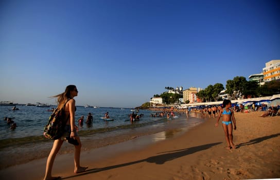 salvador, bahia / brazil - december 5, 2015: people are seen on Porto da Barra beach in the city of Salvador..