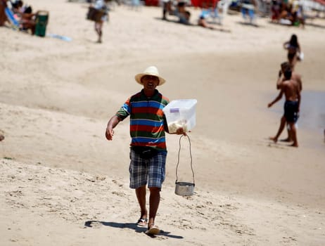 salvador, bahia / brazil - december 30, 2015: Street vendor is seen at Praia do Flamengo in the city of Salvador.