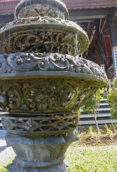 Three-level fountain in front of Hindu temple on Bali island. A multi-level water fountain with water dropping from the top. Weak streams of water spill over the edges of the fountain floors.