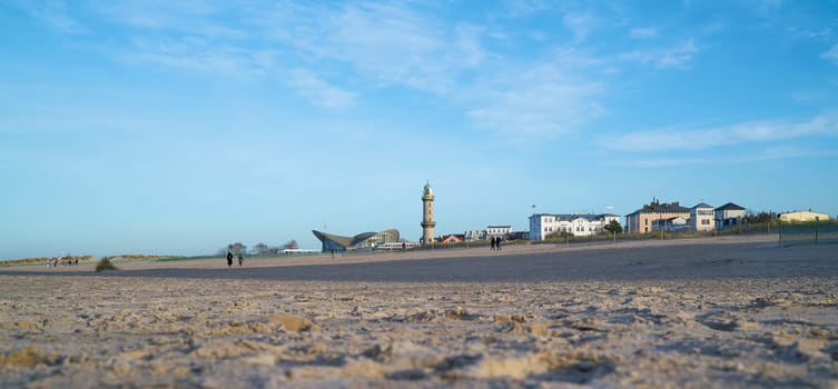 Beach of Warnemünde in Germany with view of the Landmarks Lighthouse and Teepott