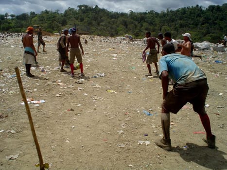 itabuna, bahia / brazil - september 22, 2011: waste pickers are seen playing football at the landfill in the city of itabuna.