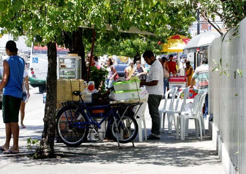 salvador, bahia / brazil - december 14, 2012: Street vendors of snacks on the sidewalk of the Pituba neighborhood in the city of Salvador.