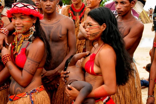 santa cruz cabralia, bahia / brazil - april 19, 2009: pataxo ethina india is seen breastfeeding her child during indigenous games in the Coroa Vermelha village in Santa Cruz Cabralia.