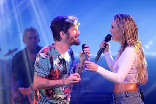salvador, bahia / brazil - december 12, 2012: Claudia Leitte, singer is seen alongside singer Saulo Fernandes during a performance in the city of Salvador.