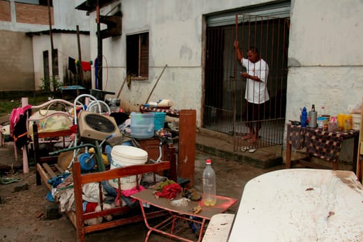 eunapolis, bahia / brazil - june 3, 2009: people remove movies from a residence invaded by rainwater that fell in the city of Eunapolis.