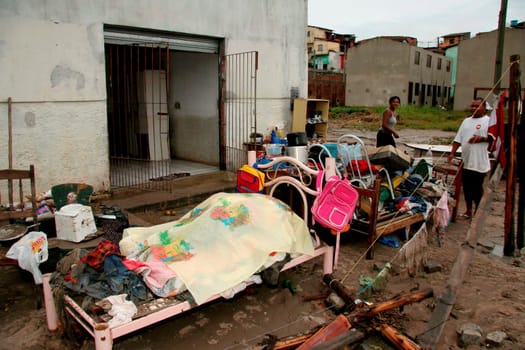eunapolis, bahia / brazil - june 3, 2009: people remove movies from a residence invaded by rainwater that fell in the city of Eunapolis.