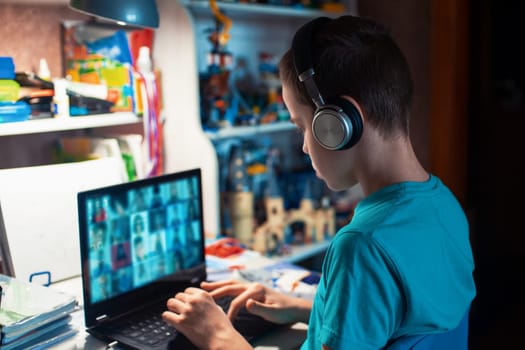 Distance learning or online education conference concept. Schoolboy studies at home and does school homework by laptop