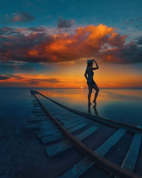 Woman at beauty sunset on salty lake