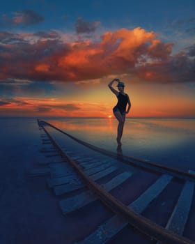 Woman at beauty sunset on salty lake