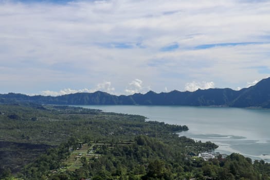 Panoramic indonesian landscape tropical island bali. Popular tourist attractions of Bali tropical island, amazing top view on Batur Indonesia. Batur lake and volcano are in the central mountains.
