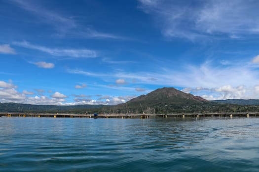 Batur volcano on Bali island, Indonesia. Active Indonesian Volcano Batur in the tropical island. Batur lake and volcano are in the central mountains of Bali near the Kintamani village, Indonesia.