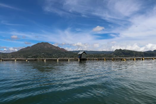 Batur volcano on Bali island, Indonesia. Active Indonesian Volcano Batur in the tropical island. Batur lake and volcano are in the central mountains of Bali near the Kintamani village, Indonesia.