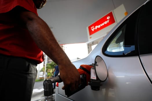 salvador, bahia / brazil - august 7, 2019: Gas station attendant making fuel supply in vehicle at gas station.