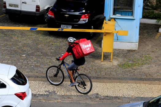 salvador, bahia / brazil - july 15, 2019: Food delivery man seen on Tancredo Neves Avenue in Salvador.