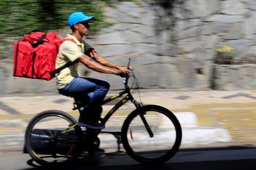 salvador, bahia / brazil - july 15, 2019: Food delivery man seen on Tancredo Neves Avenue in Salvador.