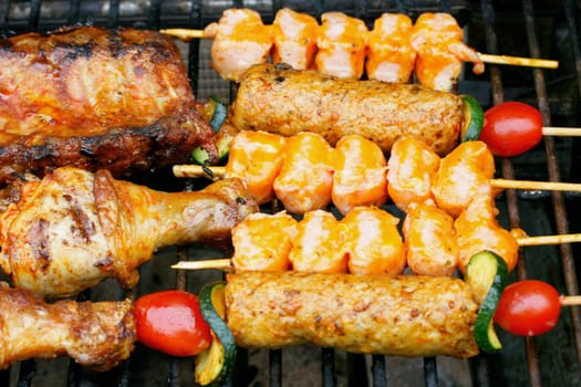 Various pieces of grilled meat on a grill grate