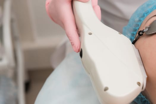 Closeup photo of procedure for laser hair removal on woman face.