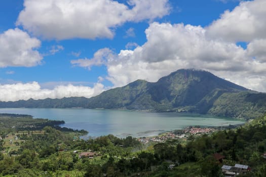 Aerial view over Lake Batur to the traditional village of Trunyan. In this village, the locals bury their deceased above ground. Terunyan is one of the culturally isolated Bali Aga village in Bali.