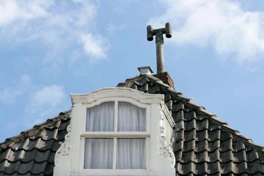 Dormer with lattice Window, blue sky in the background .