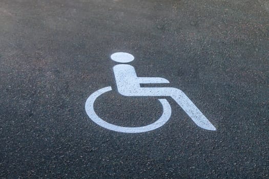 White Road marking for wheelchair users on asphalt