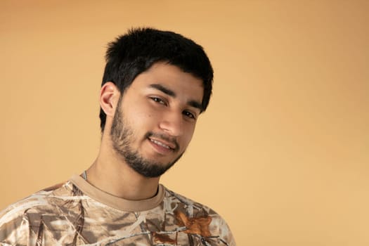 Beautiful black haired man on beige background