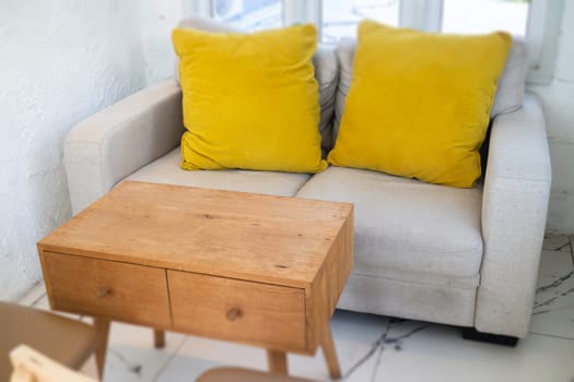Mix and match sofa with wooden furniture, stock photo