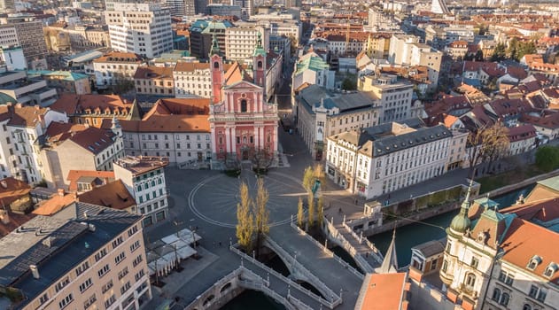 Aerial drone view of Preseren Squere and Triple Bridge over Ljubljanica river,Tromostovje, Ljubljana, Slovenia. Empty streets during corona virus pandemic social distancing measures.