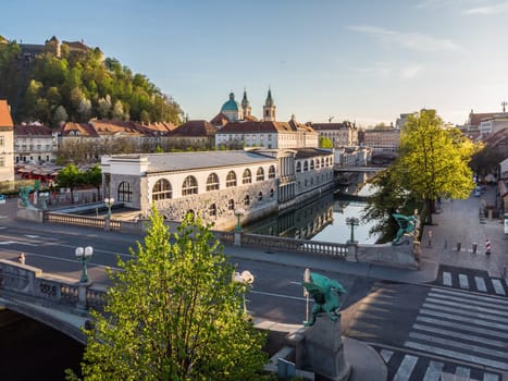 Aerial drone panoramic view of Ljubljana medieval city center, capital of Slovenia in warm afternoon sun. Empty streets during corona virus pandemic social distancing measures.