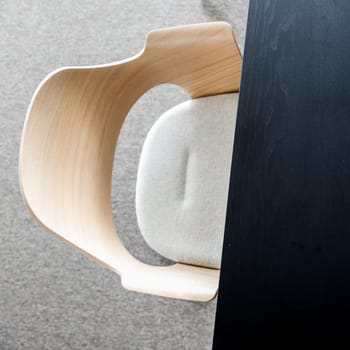 Designers armchair by black office desk. Modern minimalist workplace.