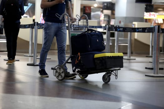 salvador, bahia / brazil - september 22, 2017: passengers are seen poking cart with suitcase in the lobby of the airport of the city of Salvador.