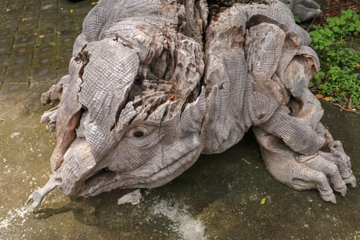 Wooden statue of a lizard. Art and work of Balinese artists. Wooden art. Komodo dragon made of piece of old wood. Big varan art statue from wooden pieces. Ubud, Bali, Indonesia. March 2020.