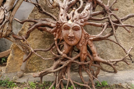 Sun with face made of tree root. Wooden decoration. Dried fibrous roots that spread beautifully to the soil surface. can be used as a background template.Art and work of Balinese artists. Ubud, Bali.