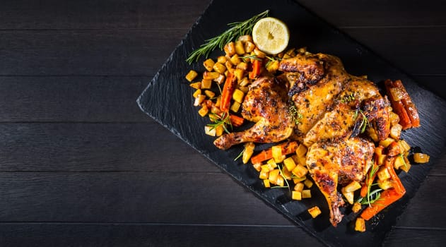 Butterflied grilled whole chicken with roasted vegetables and potatoes. Roadkill chicken style with herbs and lemon.