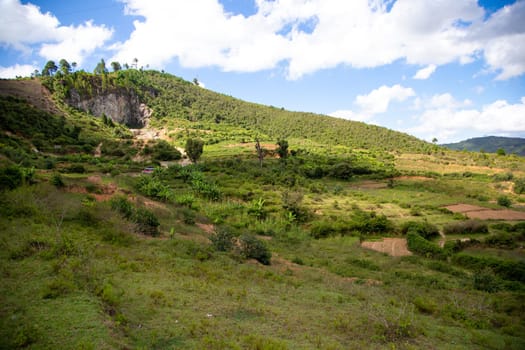 The Mountains covered with plants and a blue sky with small clouds