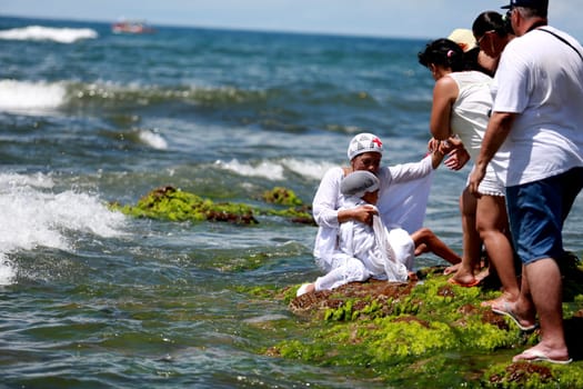 salvador, bahia / brazil - february 2, 2015: supporters of candomble are seen on the Rio Vermelho beach in the city of Salvador during a party in honor of Yemanja.