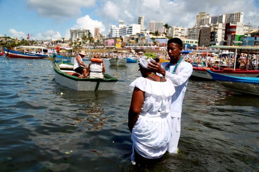 salvador, bahia / brazil - february 2, 2015: supporters of candomble are seen on the Rio Vermelho beach in the city of Salvador during a party in honor of Yemanja.