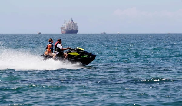 salvador, bahia / brazil - january 1, 2015: watercraft - jet sky - is seen sailing together with bathers on Boa Viagem beach in the city of Salvador.