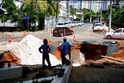 salvador, bahia / brazil - may 4, 2015: workers make repairs in a place where the pipeline broke, damaging damage on the street in the city of Salvador.