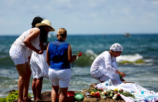 salvador, bahia / brazil - february 2, 2015: supporters of candomble are seen on the Rio Vermelho beach in the city of Salvador during a party in honor of Yemanja.