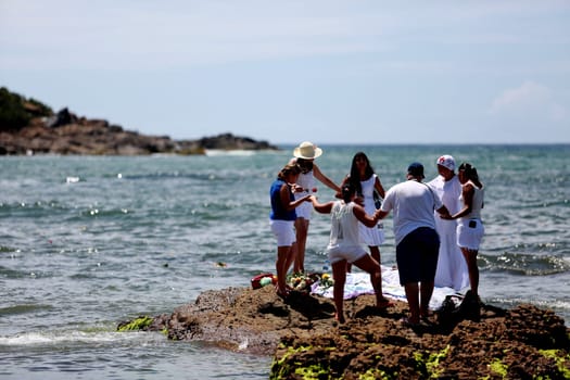 salvador, bahia / brazil - february 2, 2015: supporters of candomble are seen on the Rio Vermelho beach in the city of Salvador during a party in honor of Yemanja.