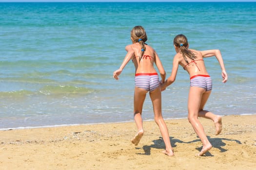Children with a run run swimming in the sea