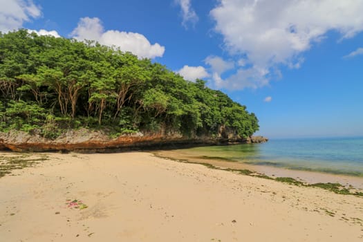 A beautiful view of Padang Padang Beach in Bali, Indonesia. Yellow fine sand.