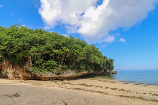 A beautiful view of Padang Padang Beach in Bali, Indonesia. Yellow fine sand.