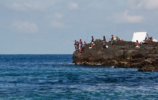 salvador, bahia / brazil - april 14, 2013: fishermen are seen in pieces on Barra beach in the city of Salvador.