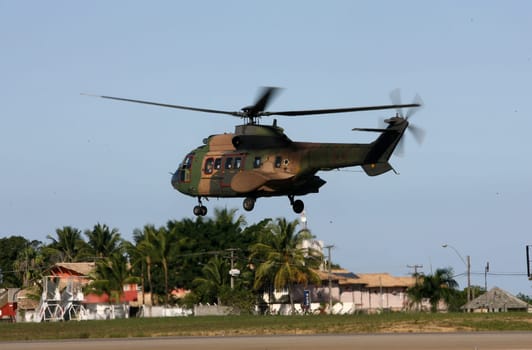 porto seguro, bahia / brazil - june 21, 2011: Eurocopter AS532 Cougar (HM-3, EB 4002) from the Brazilian Army is seen during take-off procedure at the airport runway in the city of Porto Seguro.