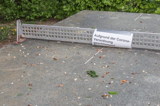 Covid-19 safety prevention. Closure prohibition sign. German text mean closed because of coronavirus restriction regulation! Keep off!