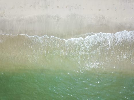 Blue ocean wave on clean sandy beach. Holidays and Travel Concept