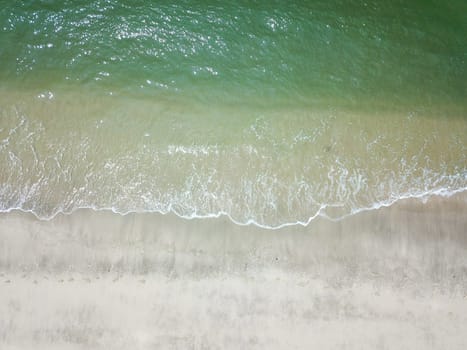 Blue ocean wave on clean sandy beach. Holidays and Travel Concept
